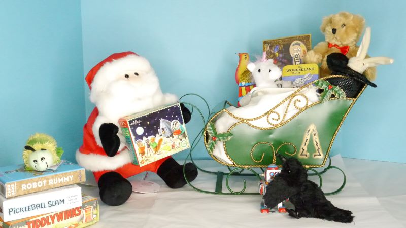 A plush Santa and little plush crow pack toys into a sleigh